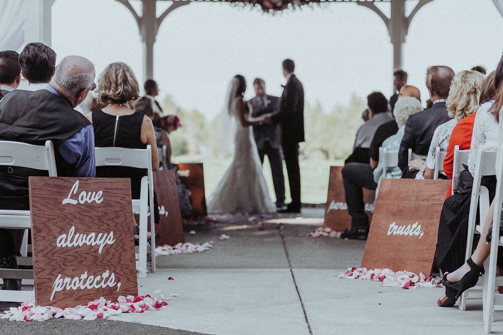 Wedding party with wood signs under the gazebo