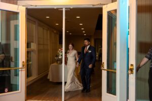 Bride and groom walking into reception