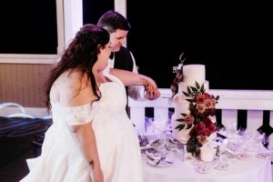 Bride and groom cutting cake