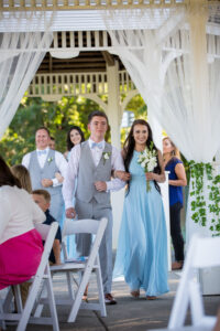 Bridesmaid and Groomsmen walking down ailse