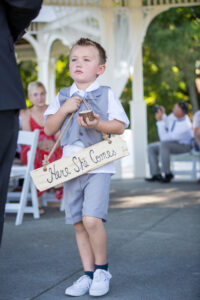 Ring barrier holding Here She Comes Sign
